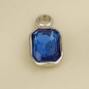 Close-up of a silver stainless steel pendant with a blue rectangle gemstone and top loop