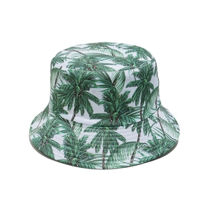 White tropical bucket hat with green palm tree print for beach vacation sun protection