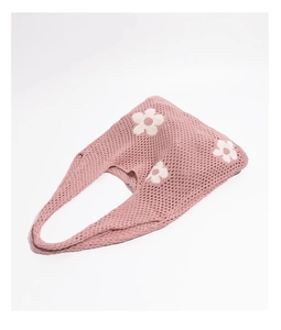 Detailansicht der rosa Stricktasche mit weißen Blumenmustern und Häkelnetz-Struktur
