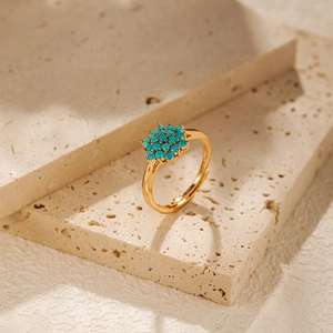 Detailed view of vintage gold ring featuring turquoise beads on a travertine stone base