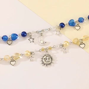 Detailed shot of bohemian beaded bracelets with celestial sun, moon, and heart charms