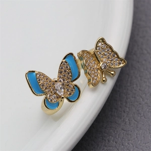 Macro detail of copper butterfly ring with blue enamel and micro-pave cubic zirconia