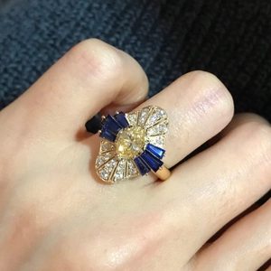 Detail of 18K gold plated ring with yellow marquise zircon and blue baguette stones