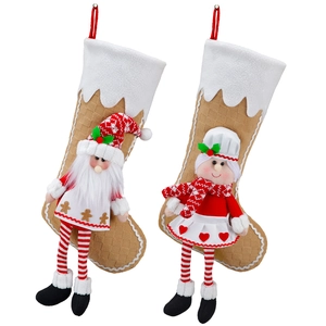 Christmas stocking decorations with plush Santa and chef designs on a white background