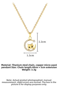 Detailed view of moon and cat pendant with sparkling zircons and gold chain necklace