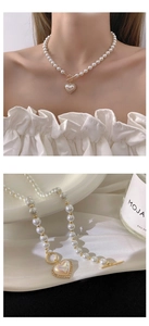Detail of luxury pearl heart necklace with gold accents and elegant toggle clasp closure