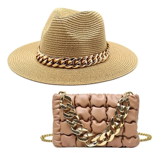 Close-up of woven straw jazz hat and quilted chain bag set in natural beige color