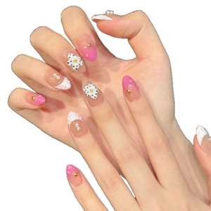 Pink gradient almond press-on nails with 3D floral accents and pearl star decorations