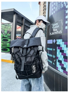 Detailed view of black roll-top backpack with functional elastic mesh net and side buckles