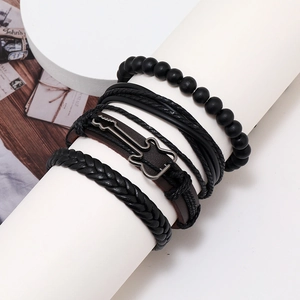 Black multilayer leather bracelet set with vintage guitar charm on white display stand