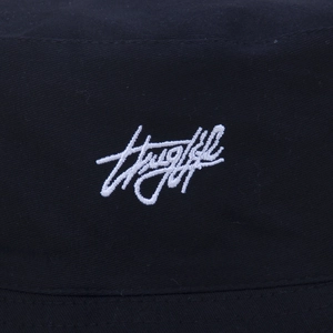 Close-up of white Thuglife 3D embroidery on a black cotton twill bucket hat texture