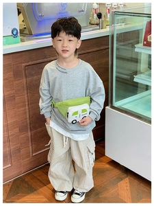 Detail view of cartoon car waist bag for kids with green and white color contrast