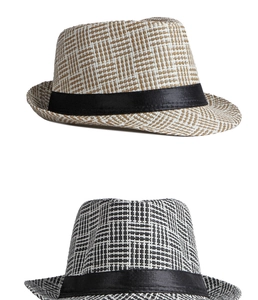 Detailed weave patterns of neutral straw jazz hats with black satin ribbon bands