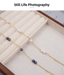 Detailed macro view of handmade wire-wrapped freshwater pearl bracelet in a velvet box