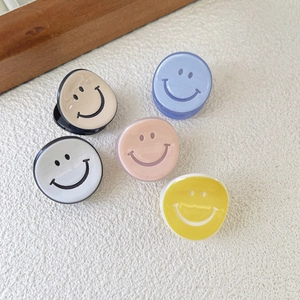 Mini acetate hair claws with cartoon smiley faces in assorted pastel colors
