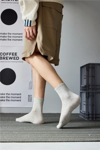 Side view of men's light grey ribbed crew socks made of breathable cotton blend fabric