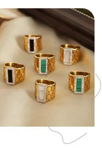 Close-up of vintage wide rings with honeycomb texture and colorful crystal inserts