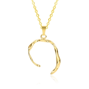 Macro shot of 18k gold plated irregular wave ring pendant on a delicate chain necklace