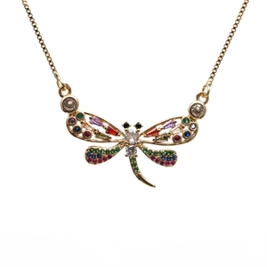 Gold dragonfly pendant necklace with vibrant multi-colored zircon stones on a white background