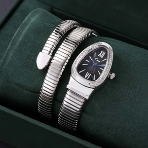 Macro detail of silver snake-shaped quartz watch with crystal bezel and black dial