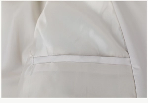 Detailed view of the smooth white inner lining and fine stitching of the jacket's pocket