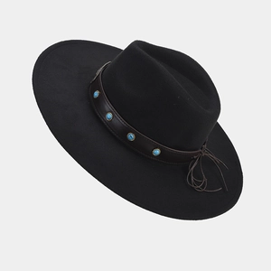 Close-up of black wide-brim felt hat with turquoise studs on brown leather band