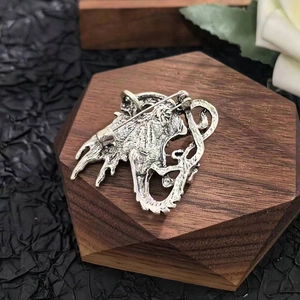 Retro silver dragon brooch with rhinestone inlay and pin back on wood base