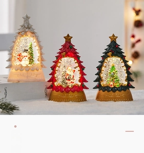 Close-up of lighted Christmas snow globe lanterns with Santa and snowman scenes