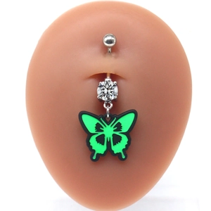 Detail of butterfly navel piercing ring with neon green wing and cubic zirconia inlay