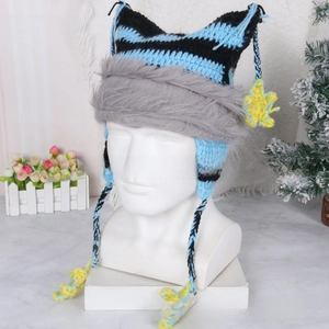 Close-up of knit cat ear hat with blue stripes, grey faux fur trim and star pendant