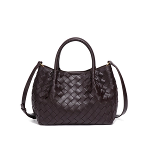 Deep brown woven leather bucket bag with top handles and adjustable shoulder strap