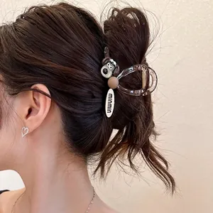 Cute cartoon dog claw clip for hair featuring a brown resin shark clip with Bitzer dog charm