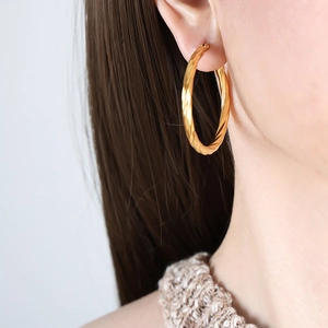 Elegant 18K gold-plated twisted hoop earrings for women, minimalist metal jewelry style