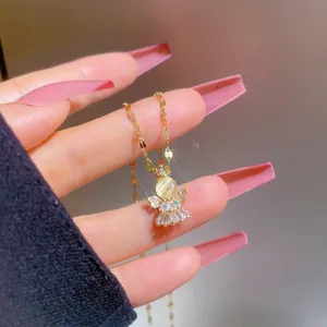 Detail of angel pendant necklace with cat eye stone and micro-set cubic zirconia