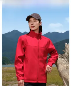 Outdoor detail of red softshell hiking jacket with zipper pockets and standing collar
