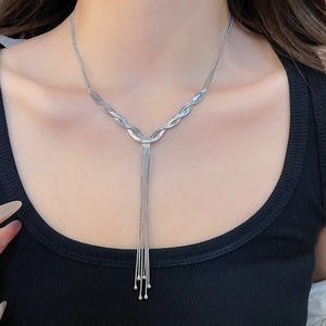 Close-up of elegant silver layered fringe necklace with flowing wavy tassels on model
