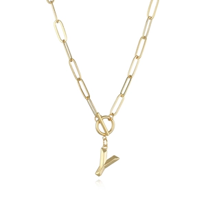 Detailed view of golden Y letter pendant with paperclip chain and OT toggle clasp