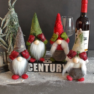 Set of four plush faceless Christmas gnomes in grey, green, red and beige festive colors