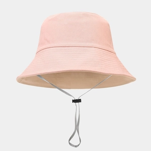 Detail of pink cotton bucket hat featuring reinforced brim stitching and gray windproof cord