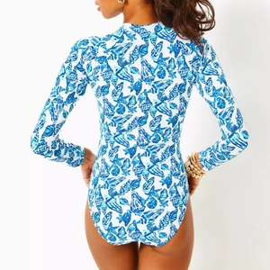 Back view of a long-sleeve women's swimsuit with blue sea shell and starfish prints