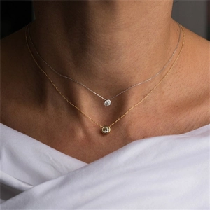 Gold and silver stainless steel birthstone necklaces set worn by a fashion model