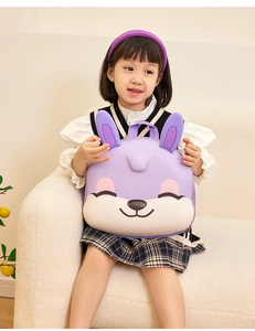 Close-up of a purple EVA rabbit backpack worn by a girl sitting on a beige sofa