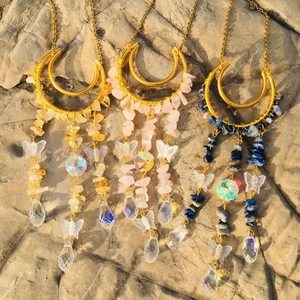 Detail of moon suncatchers with natural crystal stones and rainbow glass drops