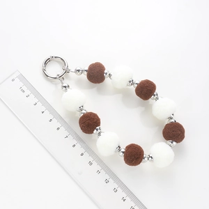 Brown and white plush ball keychain bracelet with silver beads, 15-16cm length scale view
