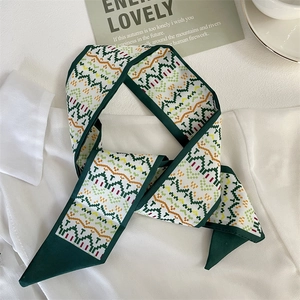 Silky geometric narrow scarf and headband with green border styled on a white shirt