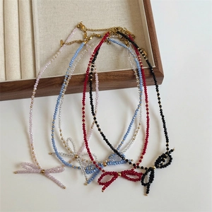 Handmade woven bow necklace featuring faceted crystal beads in assorted vibrant colors