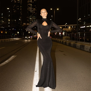 Detail of the elegant black fishtail dress featuring long sleeves and a keyhole neckline