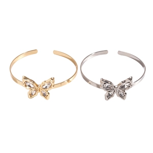 Metallic butterfly cuff bracelets in gold and silver set with pear-shaped zircons