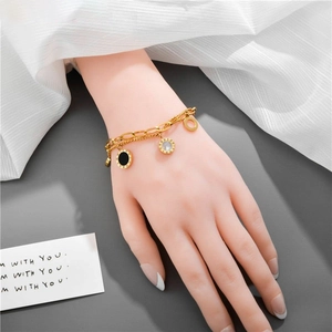 Golden double-layer titanium bracelet with Roman numeral pendants on a female model