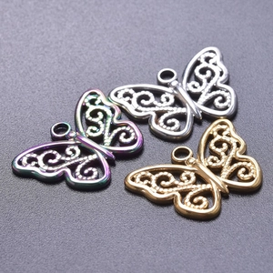 Macro shot of butterfly pendants in gold, silver and rainbow finish for DIY jewelry